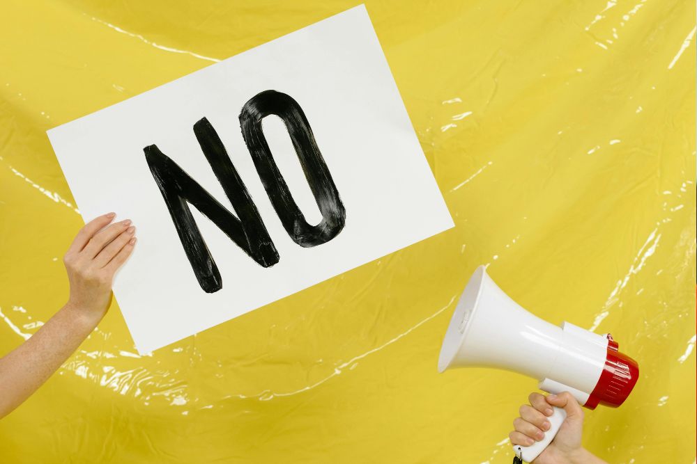 A sign saying no being held up to a megaphone